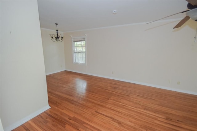 613 Brawner Pkwy, Corpus Christi, TX 78411 - unfurnished room featuring crown molding, light wood-style flooring, ceiling fan, a chandelier, and baseboards