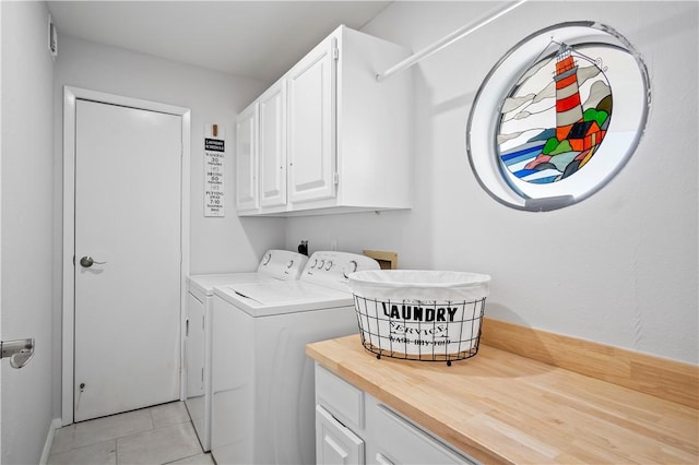 5973 State Highway 361 Unit 332, Port Aransas, TX 78373 - laundry area featuring cabinet space, washing machine and dryer, and light tile patterned floors