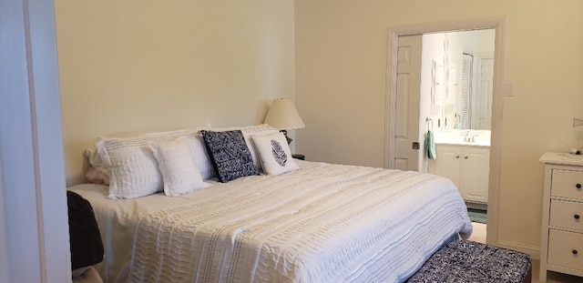 bedroom featuring sink and ensuite bathroom