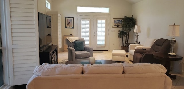 living room with vaulted ceiling and light tile patterned flooring