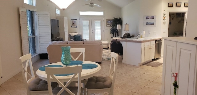 tiled dining space featuring lofted ceiling, ceiling fan, and sink