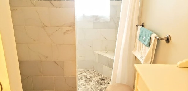 bathroom with a tile shower