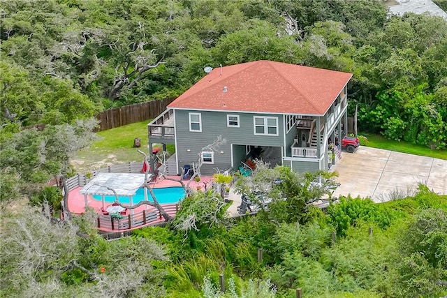 back of property with a fenced in pool, a patio area, a fenced backyard, and stairs