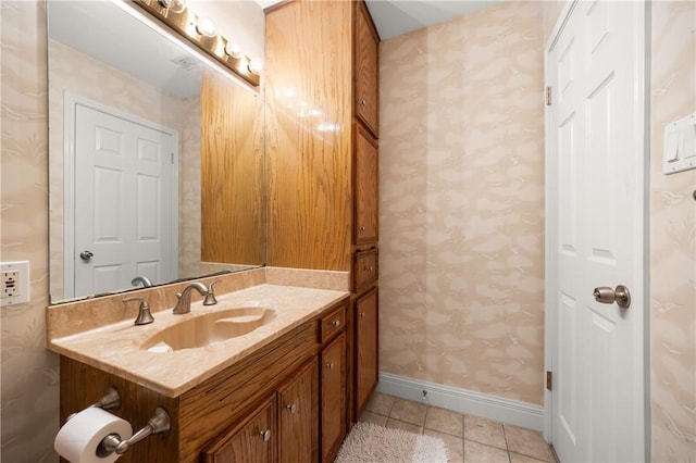 15849 El Soccorro, Corpus Christi, TX 78418 - bathroom with tile patterned floors, wallpapered walls, baseboards, and vanity