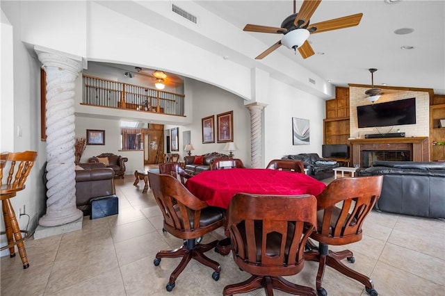 15849 El Soccorro, Corpus Christi, TX 78418 - dining area with visible vents, decorative columns, a fireplace, a ceiling fan, and light tile patterned floors