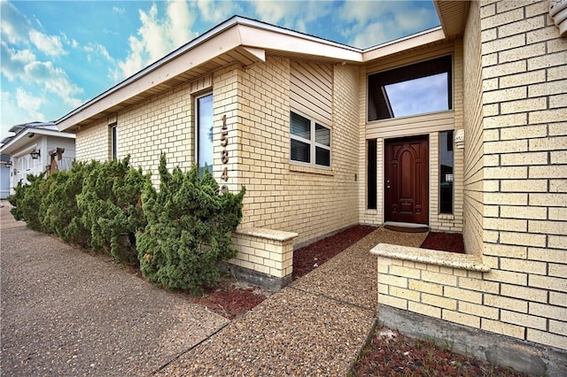 15849 El Soccorro, Corpus Christi, TX 78418 - doorway to property featuring brick siding