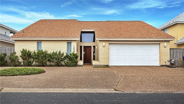 15849 El Soccorro, Corpus Christi, TX 78418 - ranch-style home featuring an attached garage, driveway, and brick siding