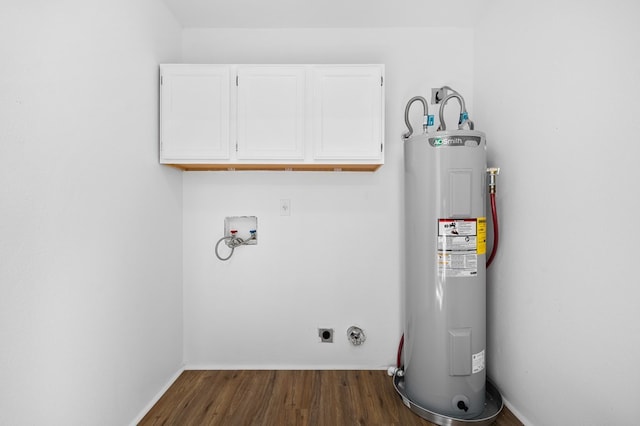 clothes washing area featuring hookup for an electric dryer, washer hookup, water heater, cabinets, and dark wood-type flooring