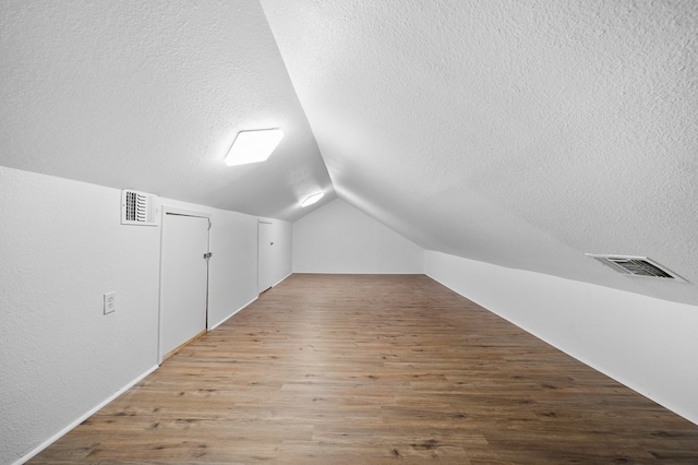 1179 Houston St S, Aransas Pass, TX 78336 - bonus room featuring a textured ceiling, wood finished floors, and lofted ceiling