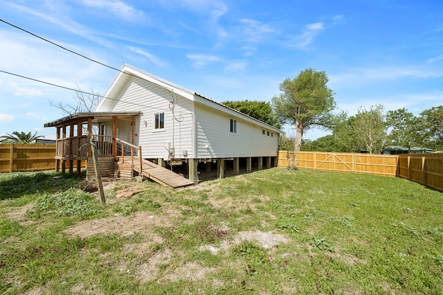 1179 Houston St S, Aransas Pass, TX 78336 - rear view of house featuring a fenced backyard, stairway, and a wooden deck