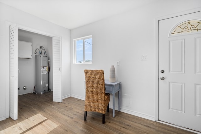 interior space featuring electric water heater and light hardwood / wood-style floors