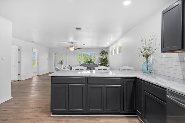 1179 Houston St S, Aransas Pass, TX 78336 - kitchen with a peninsula, stainless steel dishwasher, ceiling fan, decorative backsplash, and open floor plan
