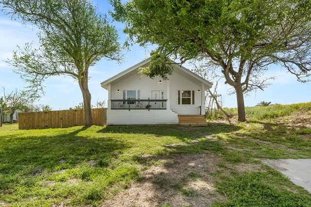 back of property featuring a wooden deck and a lawn