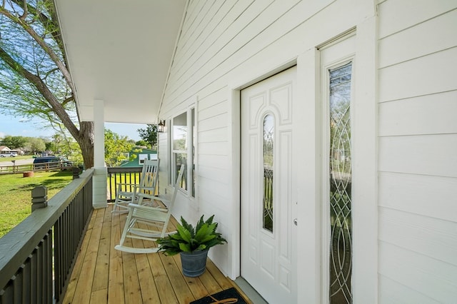 view of exterior entry featuring covered porch