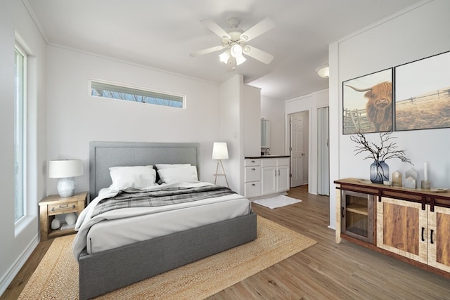 1179 Houston St S, Aransas Pass, TX 78336 - bedroom with wood finished floors, multiple windows, and a ceiling fan