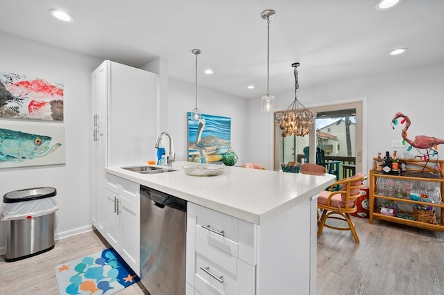 kitchen featuring pendant lighting, white cabinetry, dishwasher, sink, and light hardwood / wood-style flooring