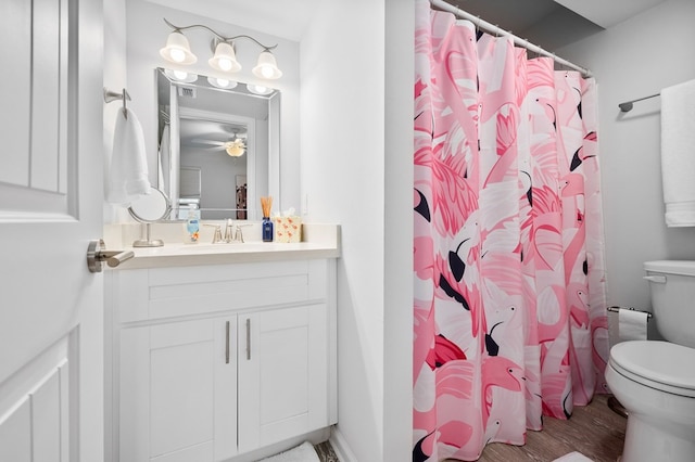 bathroom with vanity, hardwood / wood-style floors, curtained shower, and toilet