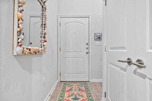 doorway to outside with light wood-type flooring