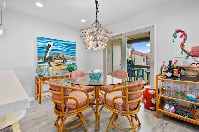 dining area featuring an inviting chandelier and light hardwood / wood-style floors