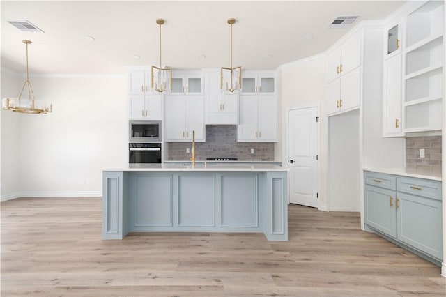 3618 Perry, Corpus Christi, TX 78410 - kitchen featuring appliances with stainless steel finishes, a chandelier, tasteful backsplash, white cabinets, and ornamental molding