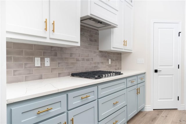 3618 Perry, Corpus Christi, TX 78410 - kitchen with stainless steel gas cooktop, light wood-style floors, tasteful backsplash, and light stone countertops