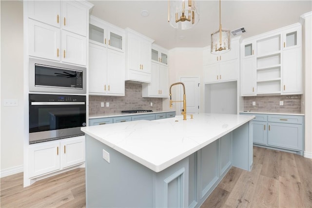 3618 Perry, Corpus Christi, TX 78410 - kitchen featuring wall oven, a chandelier, decorative backsplash, and light wood-style flooring
