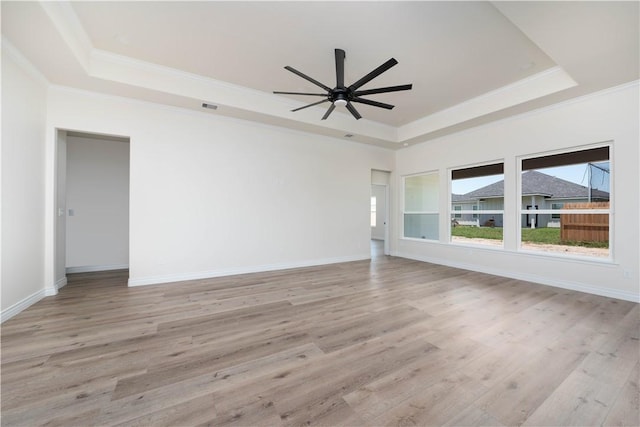 3618 Perry, Corpus Christi, TX 78410 - unfurnished room with a raised ceiling, crown molding, light wood-style flooring, ceiling fan, and baseboards