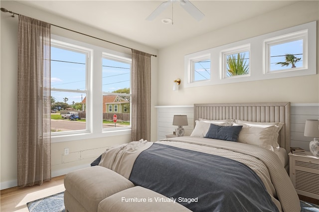 bedroom featuring hardwood / wood-style floors and ceiling fan