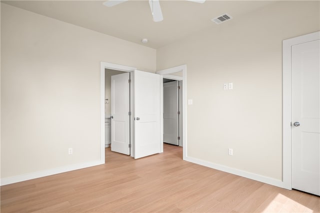 unfurnished bedroom with ceiling fan and light wood-type flooring