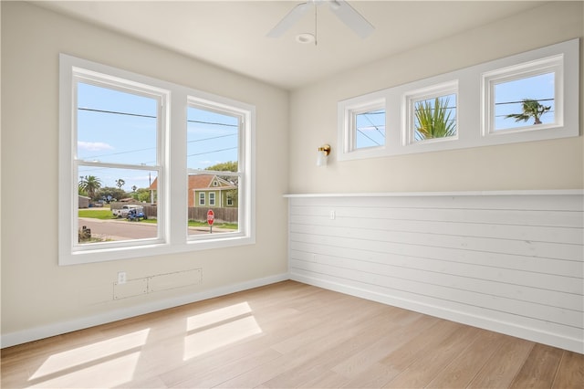 empty room with ceiling fan and light wood-type flooring