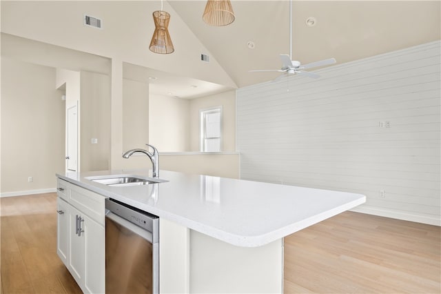 kitchen with a center island with sink, white cabinetry, sink, and dishwasher