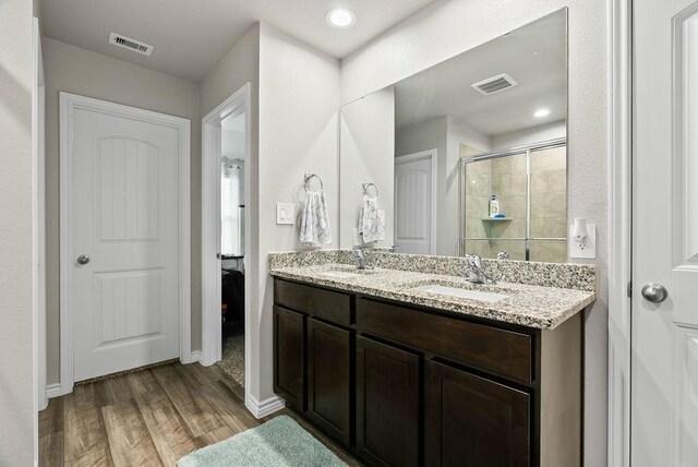 7753 Lariat Toss Dr, Corpus Christi, TX 78414 - full bathroom with a stall shower, wood finished floors, double vanity, and baseboards