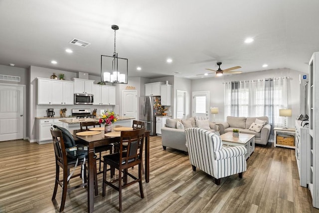 7753 Lariat Toss Dr, Corpus Christi, TX 78414 - dining space with wood finished floors, ceiling fan, recessed lighting, and a chandelier