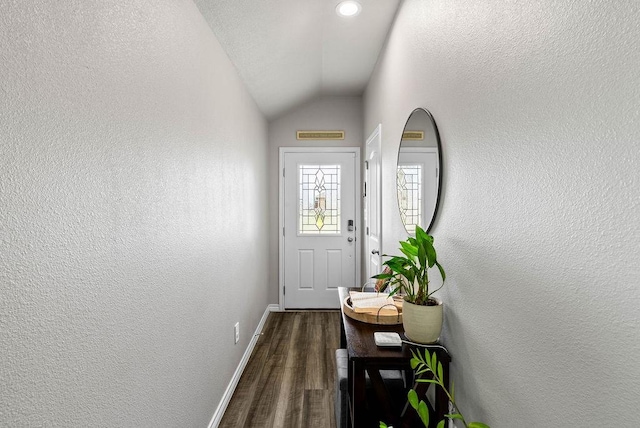 7753 Lariat Toss Dr, Corpus Christi, TX 78414 - doorway with dark wood finished floors, vaulted ceiling, baseboards, and a textured wall
