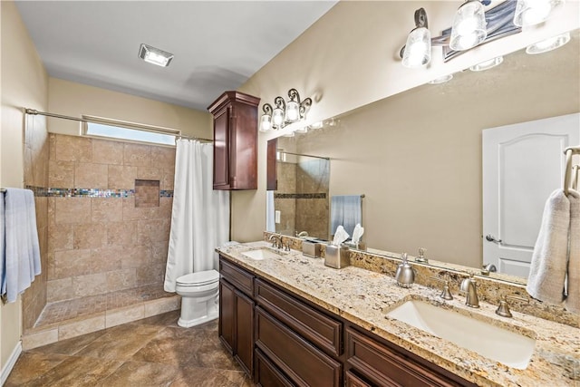 5514 King Trl, Corpus Christi, TX 78414 - bathroom featuring tiled shower, double vanity, and toilet