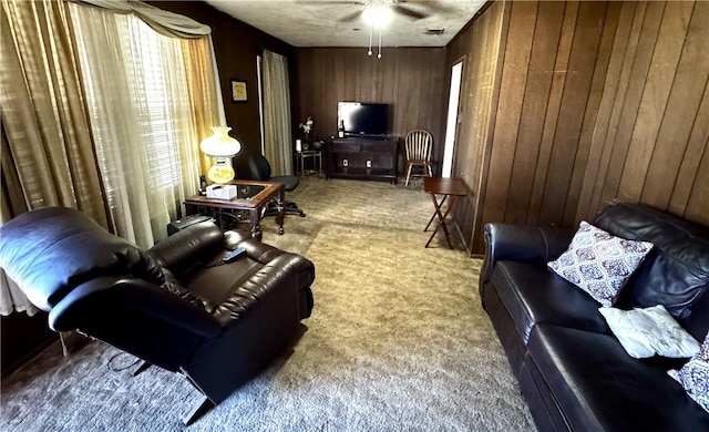 carpeted living area with visible vents and wood walls