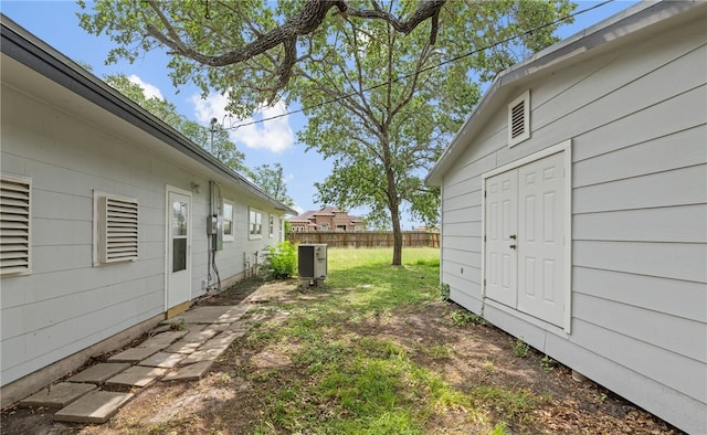 620 E 9th St, Bishop, TX 78343 - view of yard featuring central air condition unit and fence