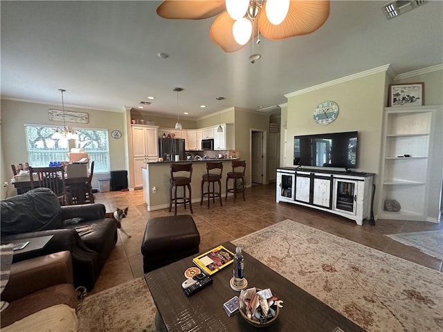113 N Santa Clara Dr, Rockport, TX 78382 - living room with ornamental molding, tile patterned floors, ceiling fan, a chandelier, and recessed lighting