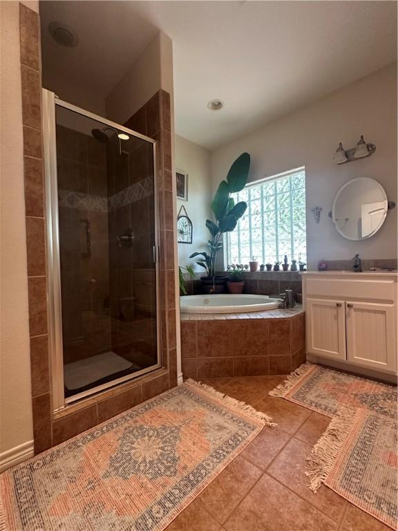 113 N Santa Clara Dr, Rockport, TX 78382 - bathroom featuring a bath, tile patterned floors, vanity, and a stall shower