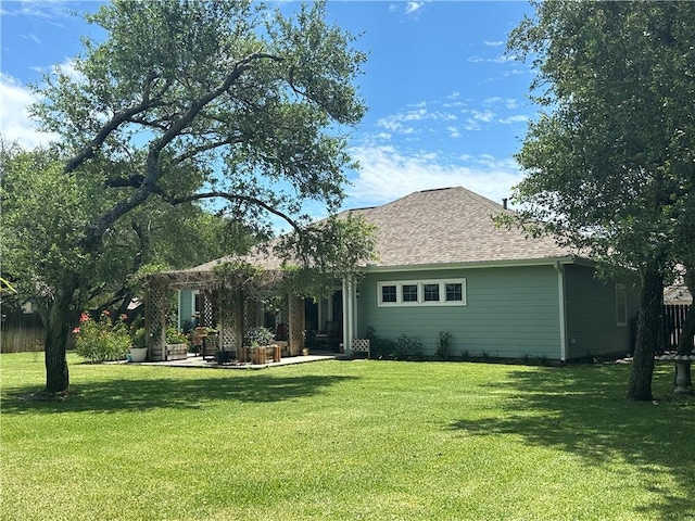 113 N Santa Clara Dr, Rockport, TX 78382 - rear view of house featuring a lawn, a patio, and a shingled roof
