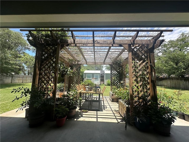 113 N Santa Clara Dr, Rockport, TX 78382 - view of patio featuring a pergola, an outdoor structure, and outdoor dining area
