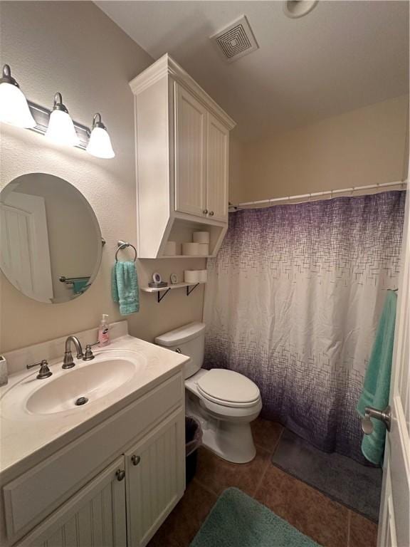 113 N Santa Clara Dr, Rockport, TX 78382 - bathroom with vanity, toilet, and tile patterned floors