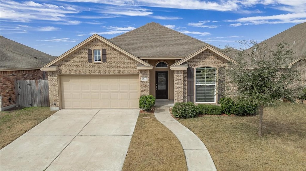 view of front of home with a garage and a front yard