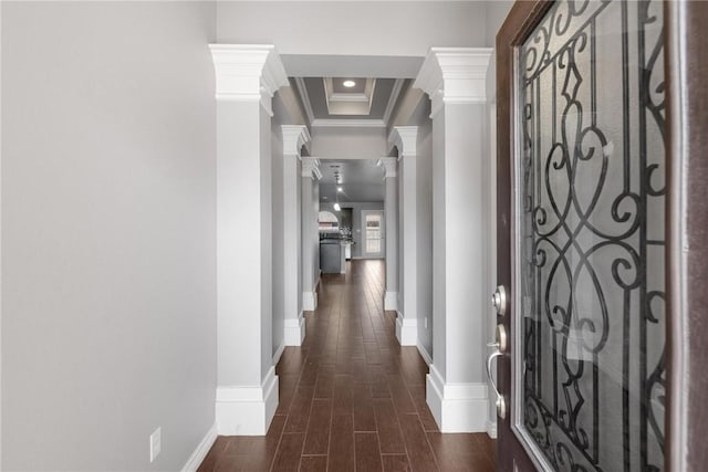 hallway with ornate columns, crown molding, and a tray ceiling