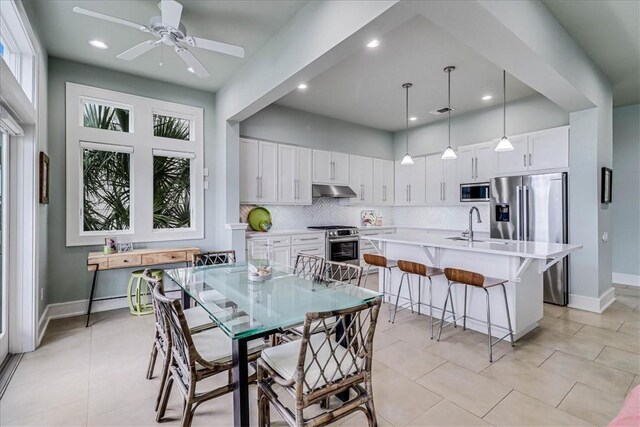 dining room with french doors, ceiling fan, and light tile patterned flooring