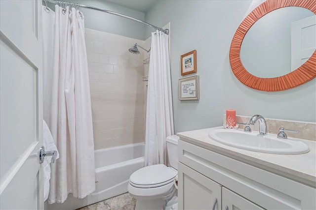 full bathroom with vanity, shower / tub combo, and toilet