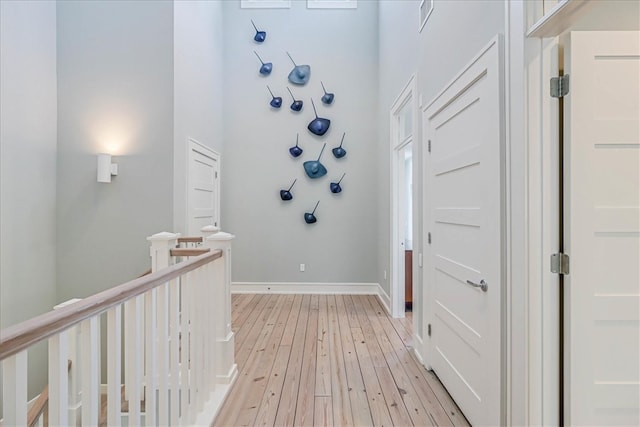 foyer entrance featuring light hardwood / wood-style flooring and a high ceiling