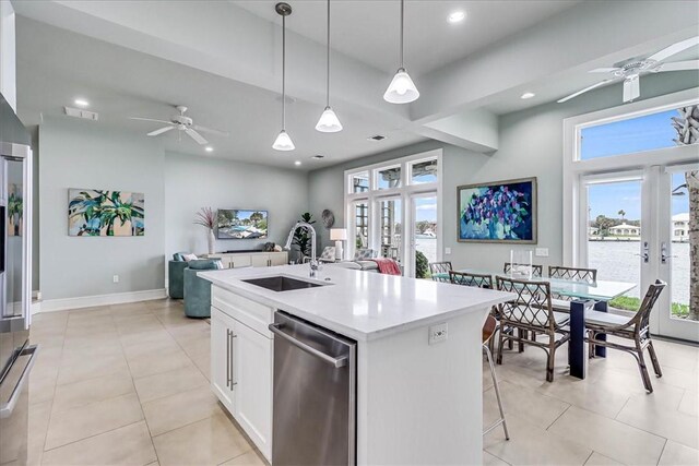 dining area featuring ceiling fan, sink, and light tile patterned floors