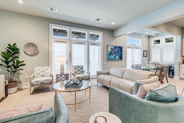 living room with ceiling fan and plenty of natural light