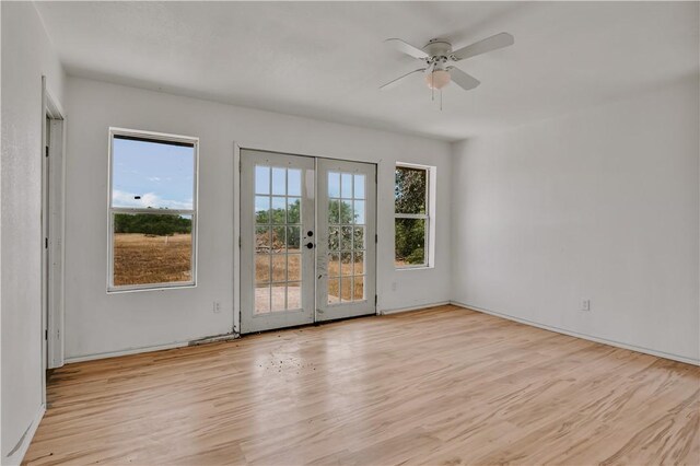 5367 Paloma Trl, Robstown, TX 78380 - spare room featuring french doors, wood finished floors, ceiling fan, and baseboards